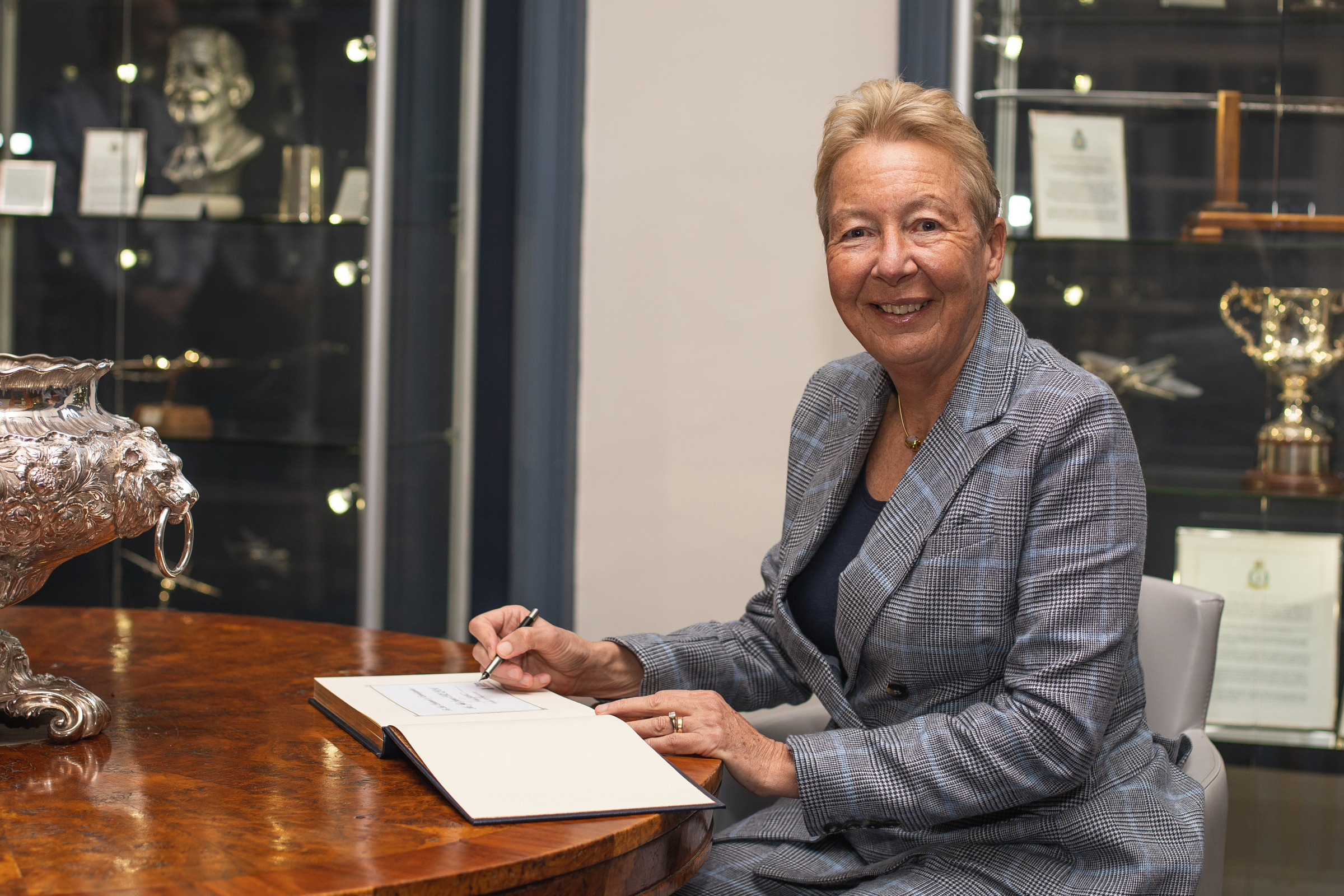 Mrs Spence signs the visitors’ book at RAF Wittering